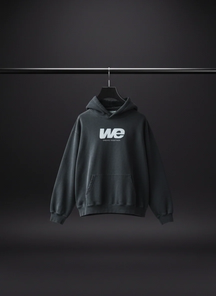 WE Hoodie in After Dark: sun-faded black hoodie with the WE mark on the chest